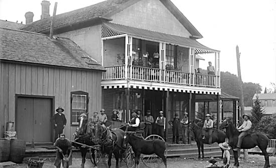 Men, boys, and horses assembled outside Dockstader's Store, Haney, B.C.
